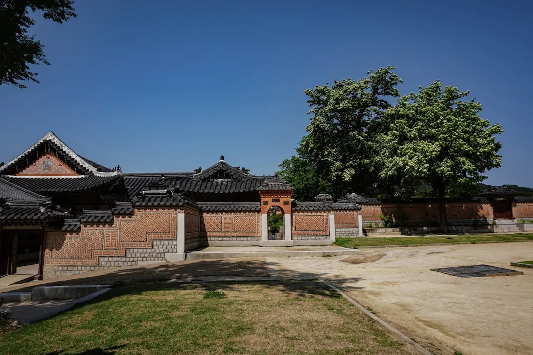 Traditional Korean palace architecture under a clear blue early-June sky