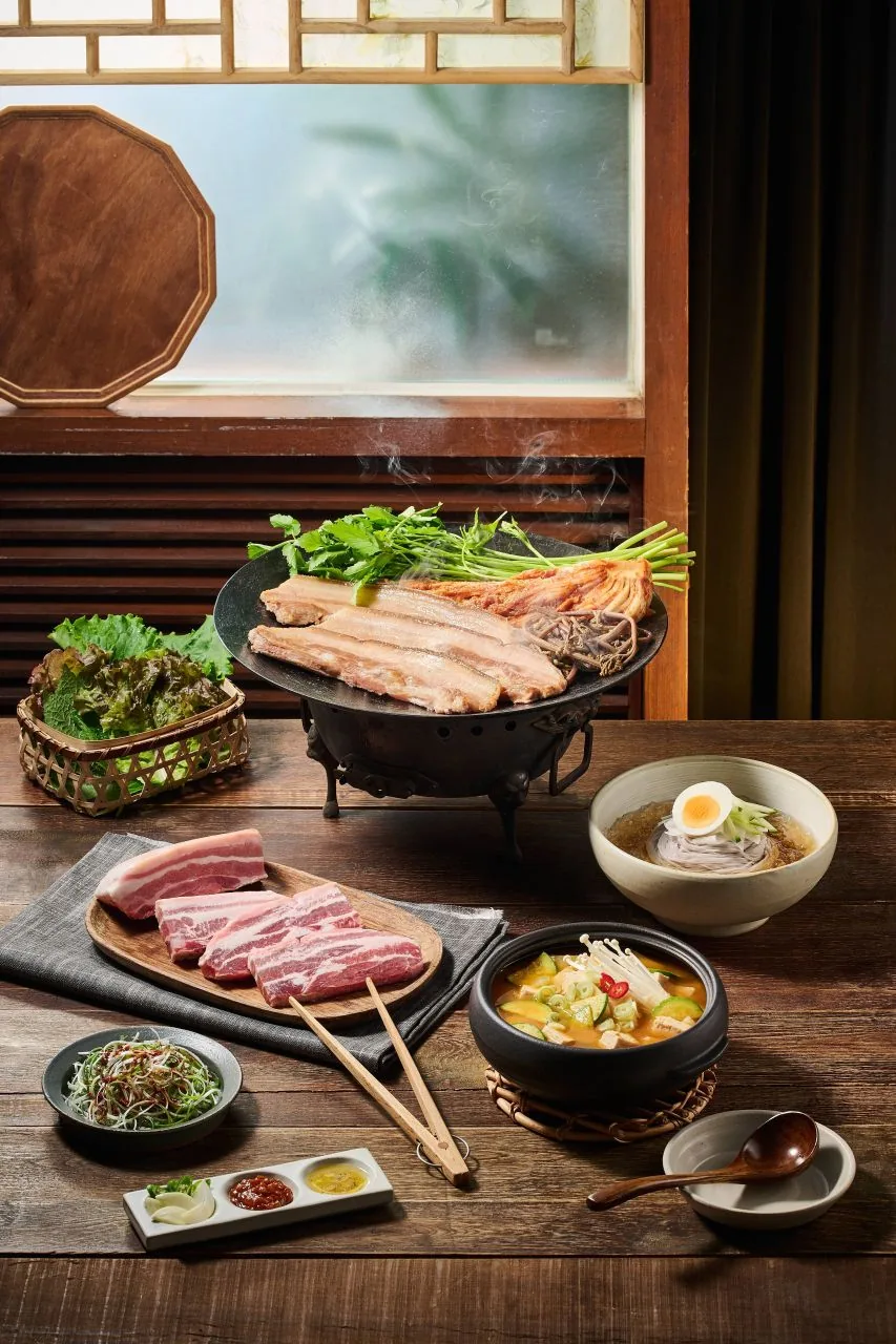 Samgyeopsal pork belly grilling at a Korean BBQ table
