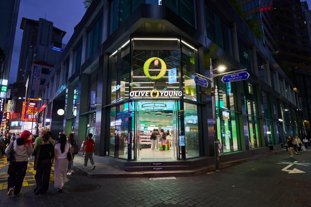 Corner store with people walking by at night