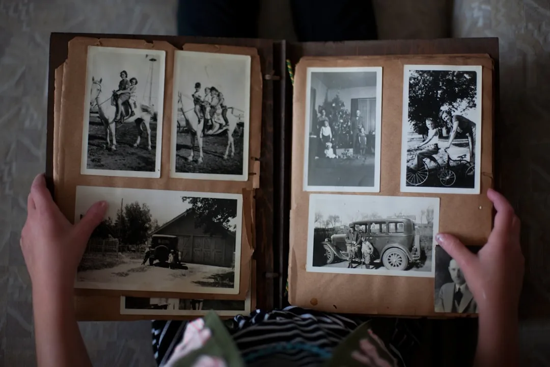 Person flipping through an old photo album, the kind of nostalgic snapshot Koreans call someone's Leeds days