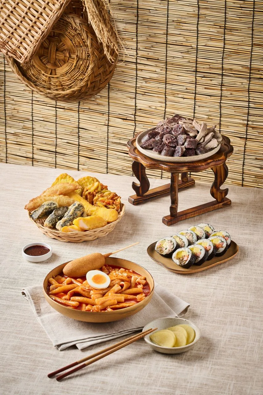 Close-up of chewy cylindrical rice cakes (tteok) used in tteokbokki, showing their texture