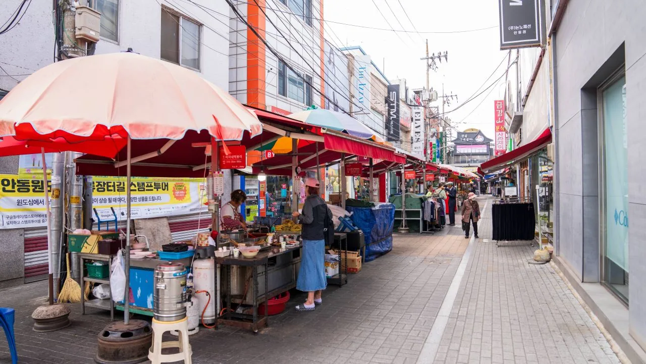 A row of tteokbokki restaurants lining a Korean street food alley